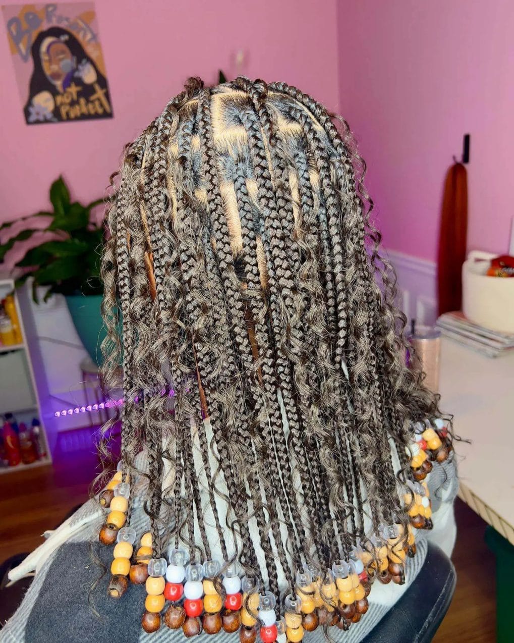 Cornrow braids with brown, caramel, and cream wooden beads transitioning to waves.