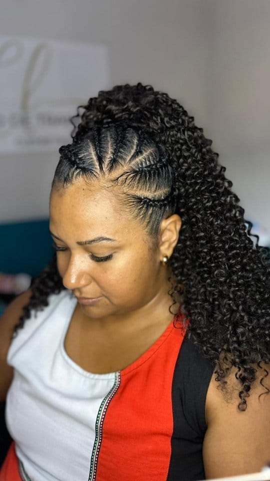 Defined cornrows at the front leading to an expanse of voluminous curls