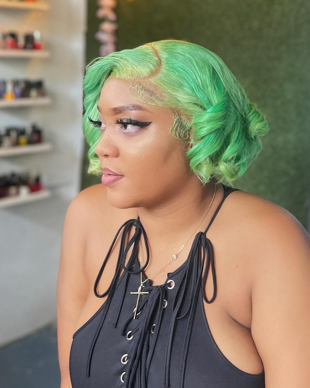 Vibrant curly green bob with patterned straight fringe