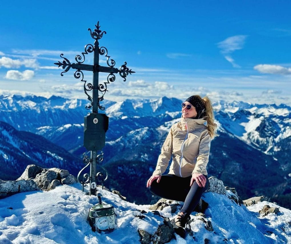 Hiker with bouncy curled ponytail and headband in crisp mountain air