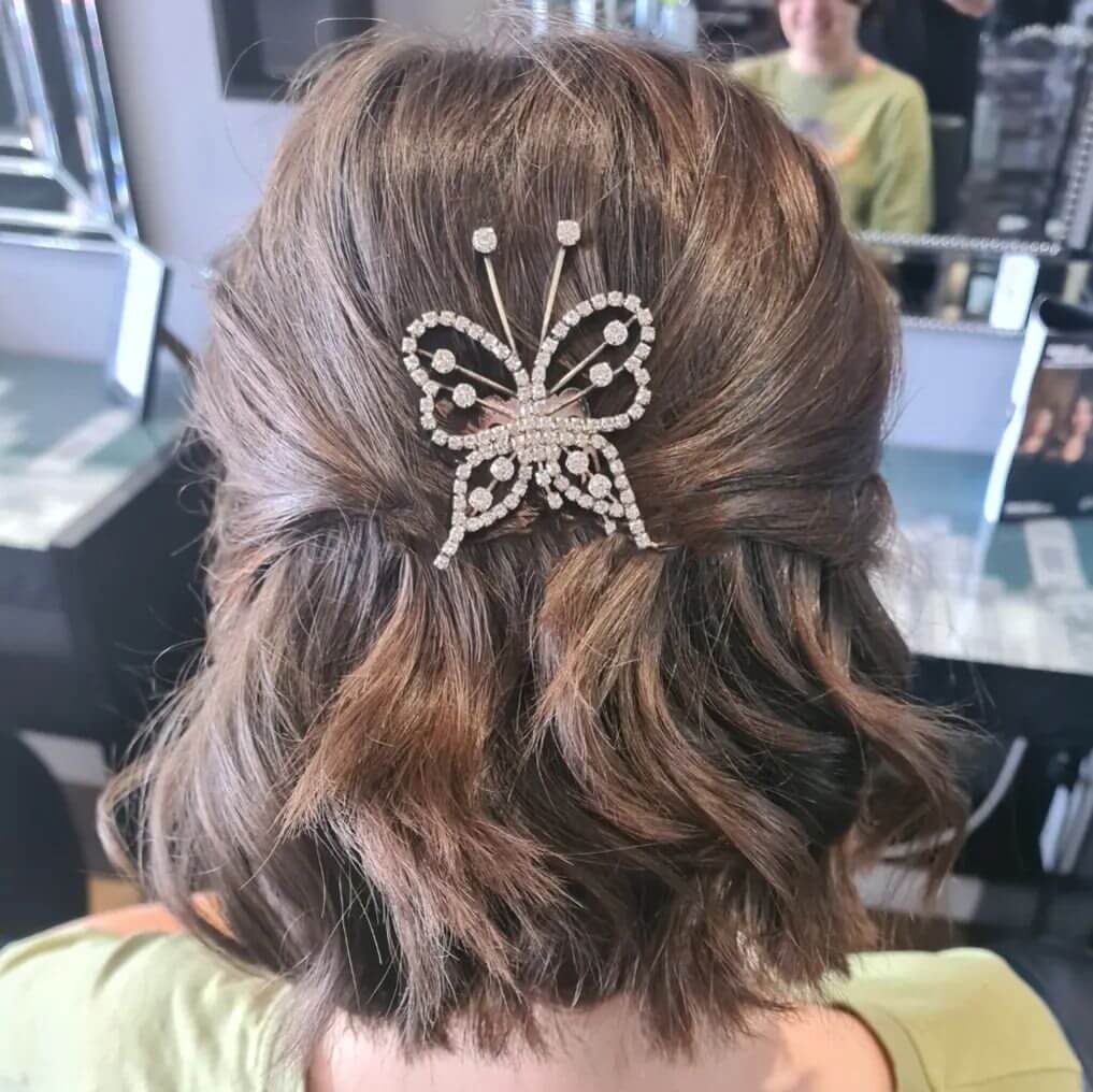 Dark brown bob with playful waves and butterfly clip