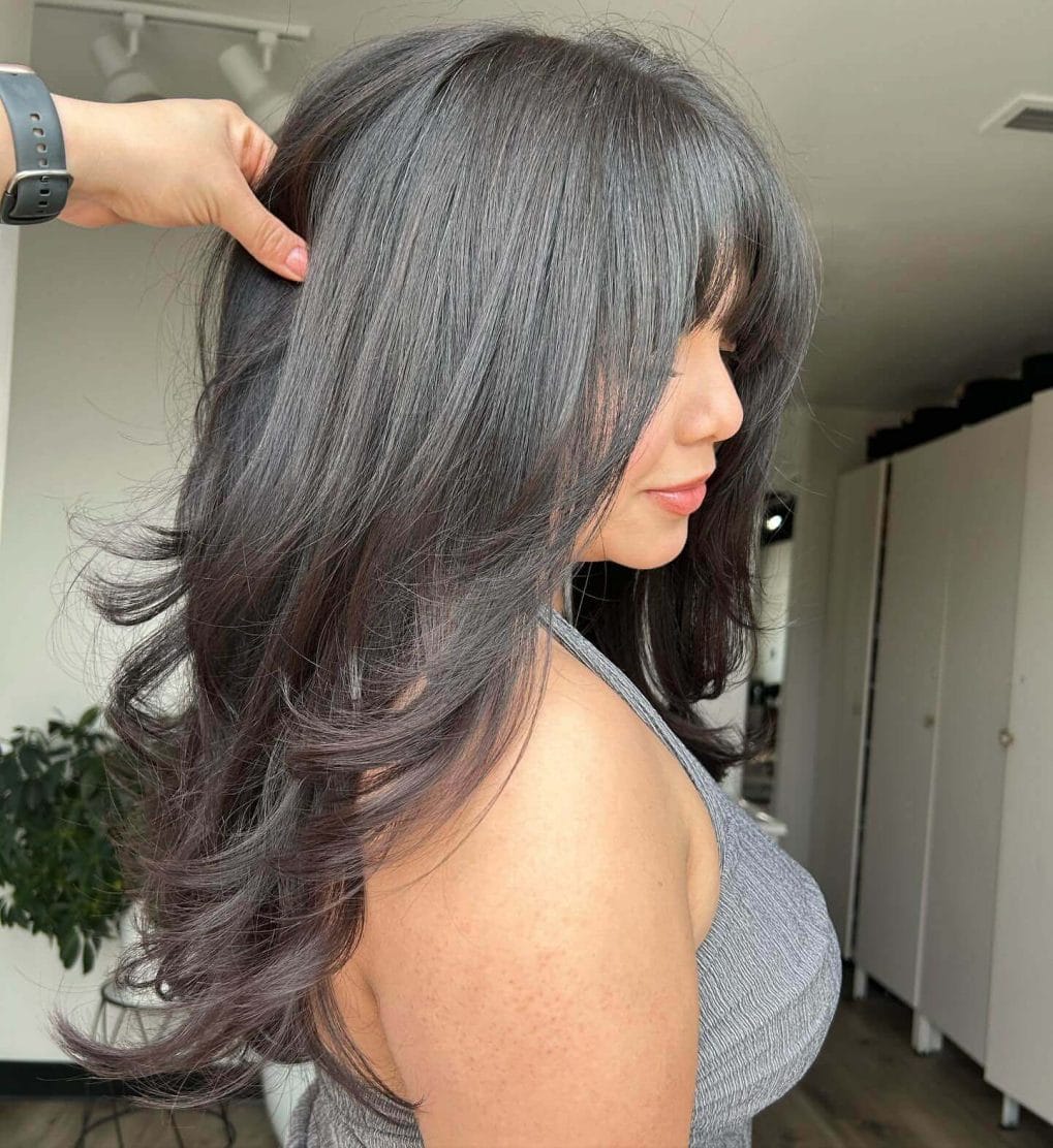 Dark layers with full bangs trendy 90s look
