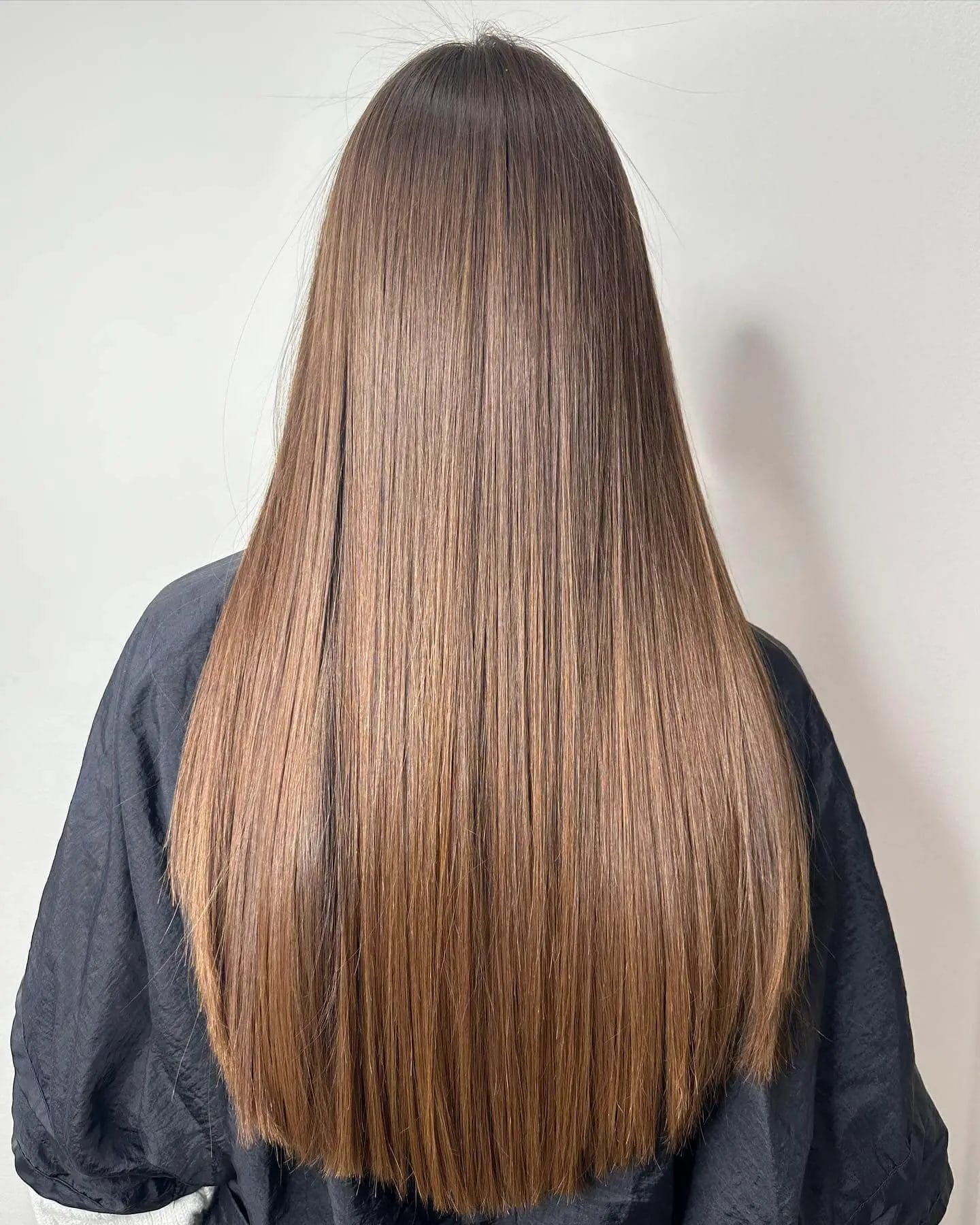 Seamless deep brunette to chestnut U-shaped hair with a gentle flow.
