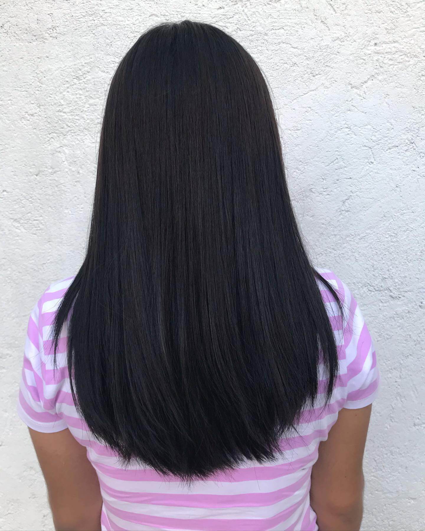 Deep lustrous U-shaped haircut with uniform tone and graceful layered movement.