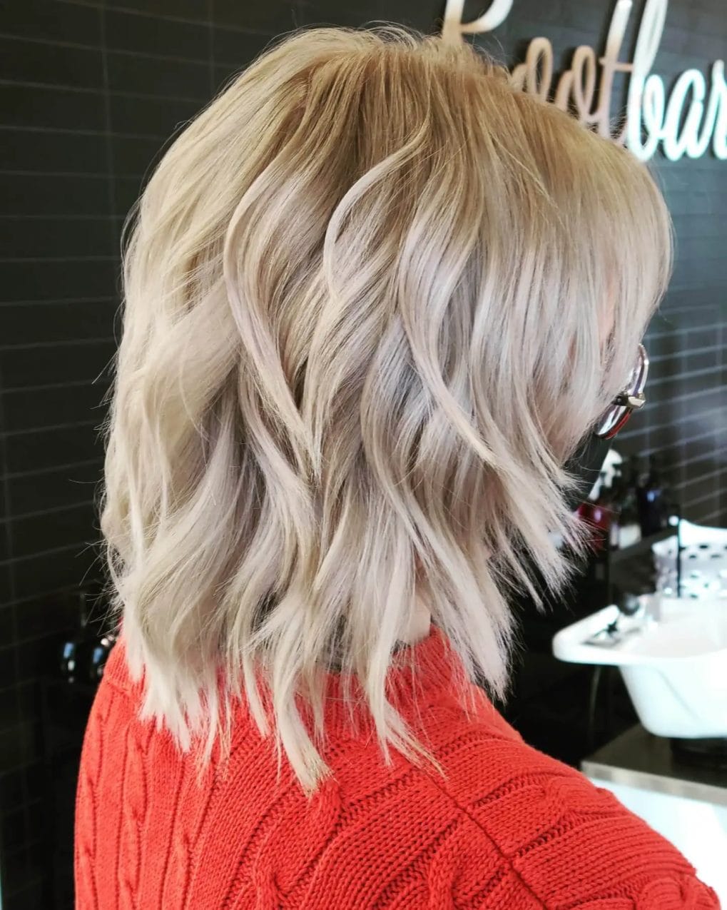 Blond wavy bixie with textured layers adding depth and dimension.