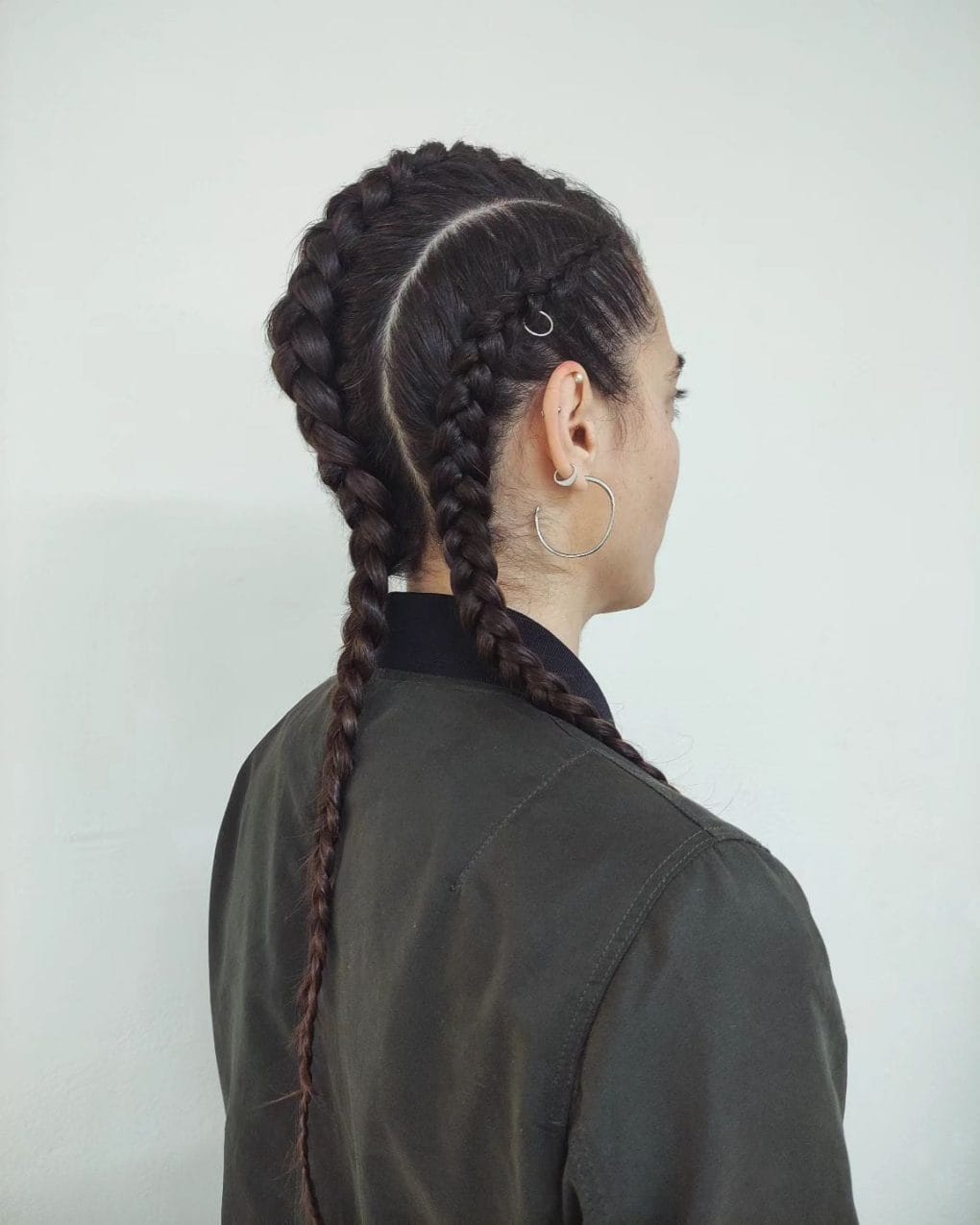 Neat triple Dutch braids with subtle highlights and hoops for softball
