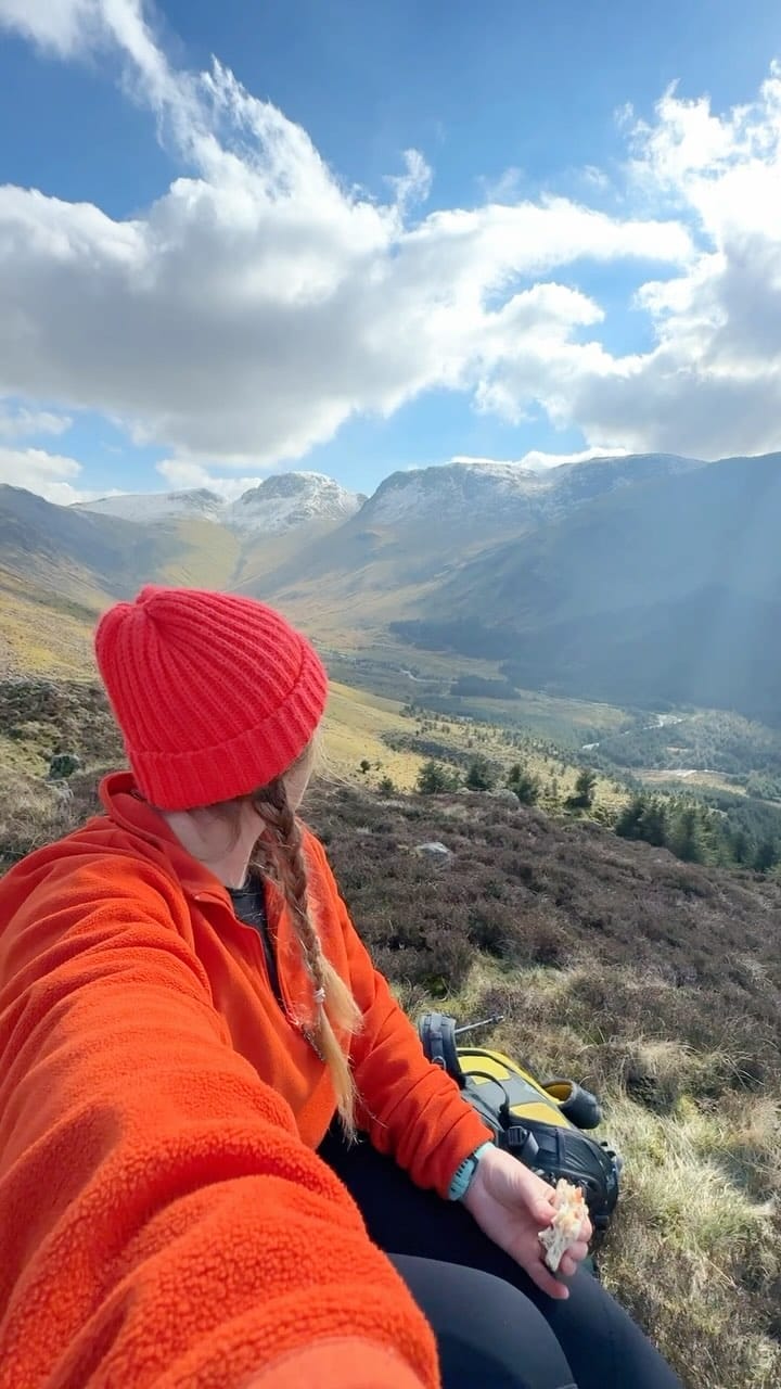 Two braids under bright winter hat for chilly hikes