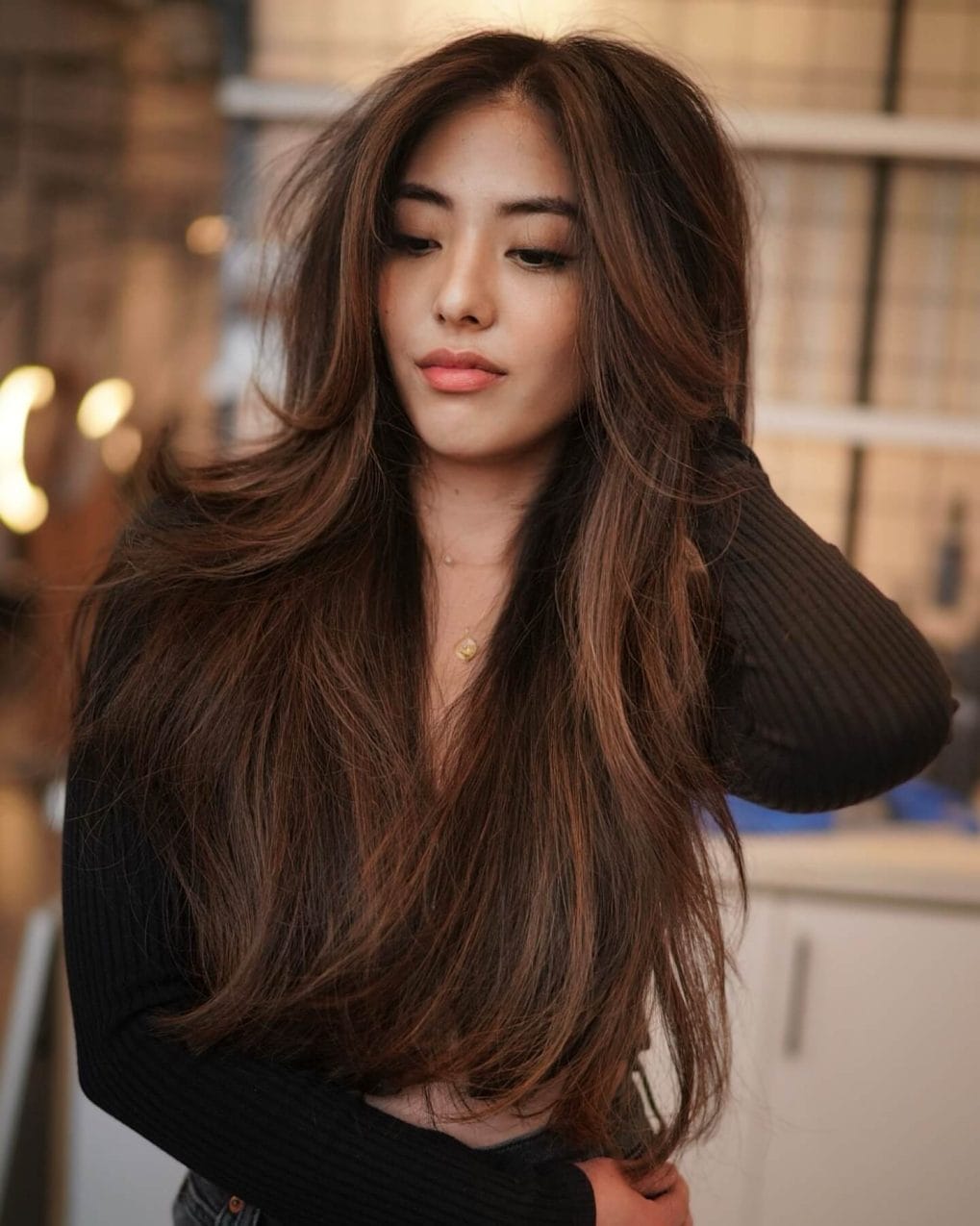 Chocolate to caramel balayage in long layers, perfect for a dynamic winter look.