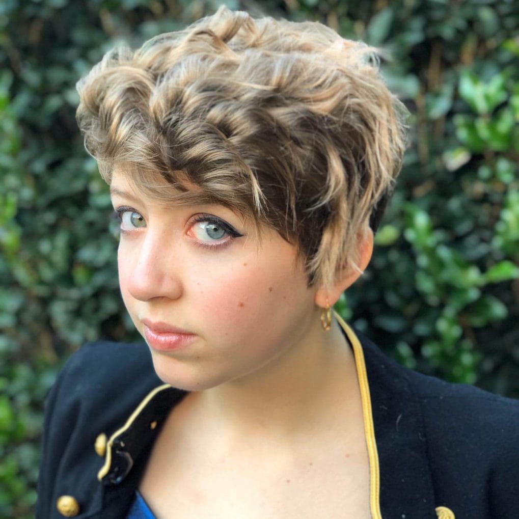 Edgy pixie cut with tousled curls and highlights