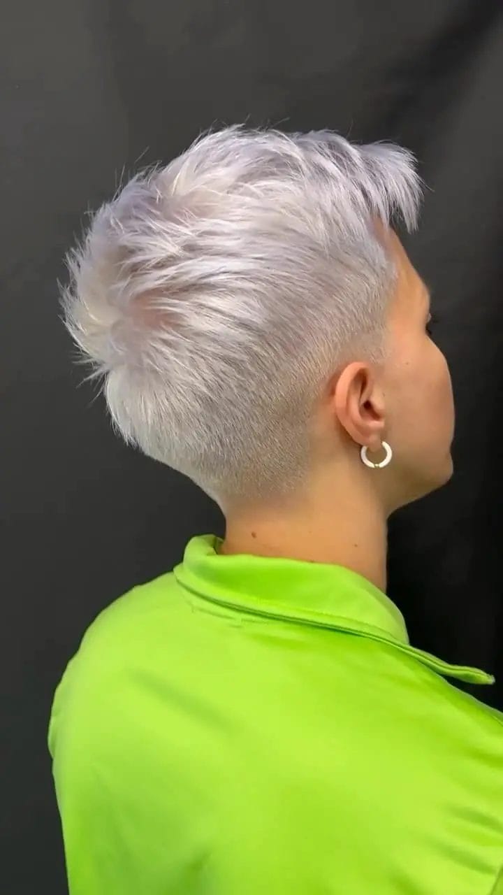 Bold silver-blonde pixie cut with textured top and buzzed sides