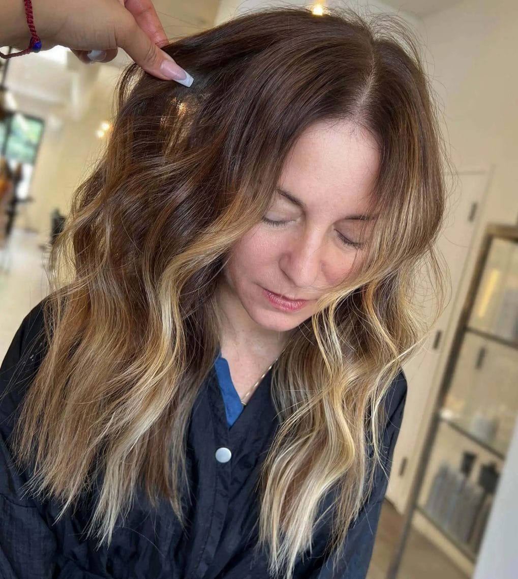 Effortless beachy look with sun-kissed balayage on hair.