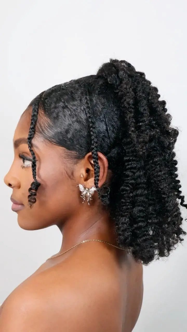 Half-up with braids elegantly framing the face with natural curls below