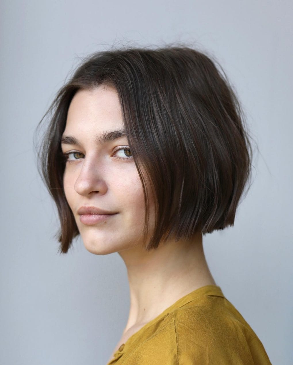 Timelessly elegant straight dark brown bob with side part