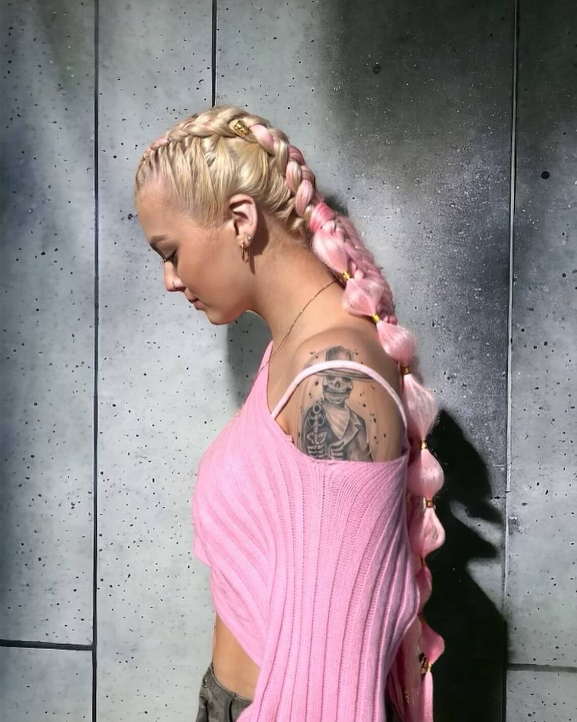 Platinum French braid with interlaced soft pink ribbons and petal accents