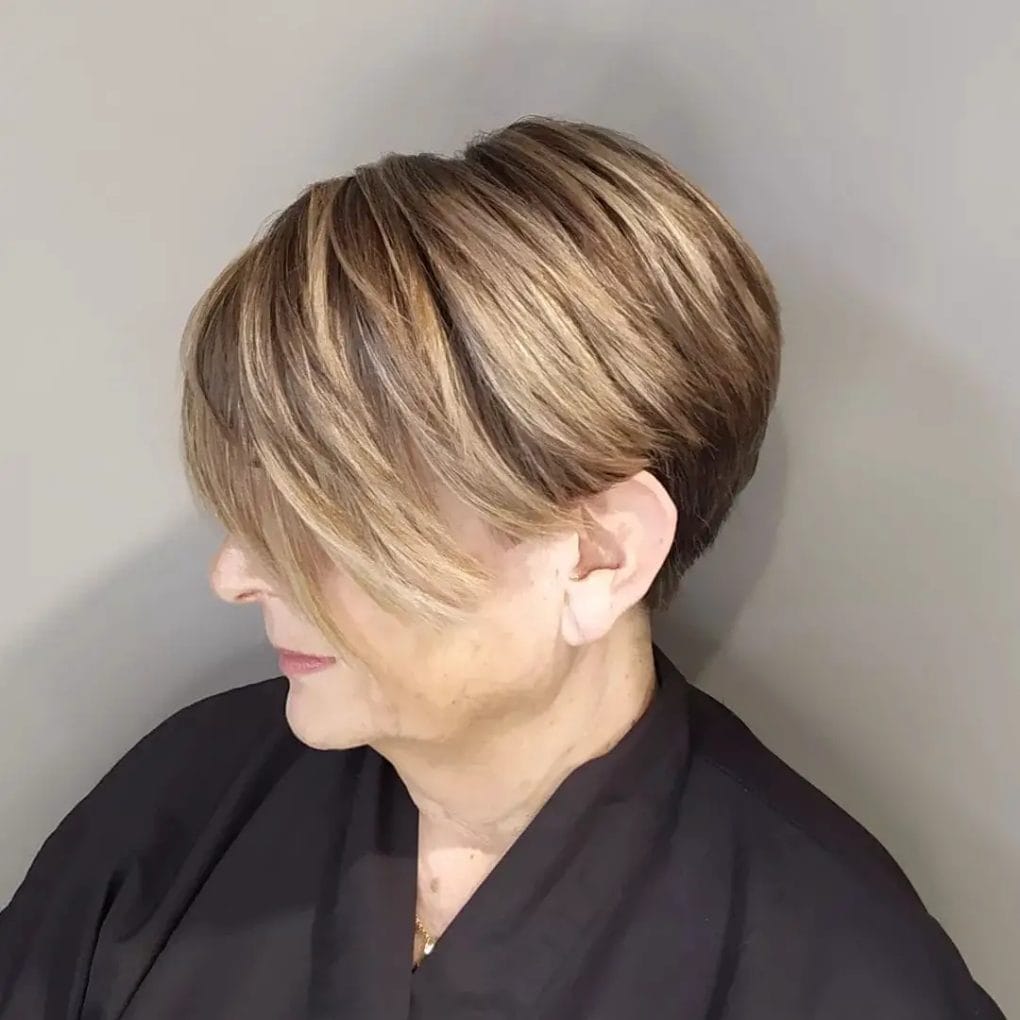 Honey and light brown highlighted pixie bob with playful side fringe and tight sides