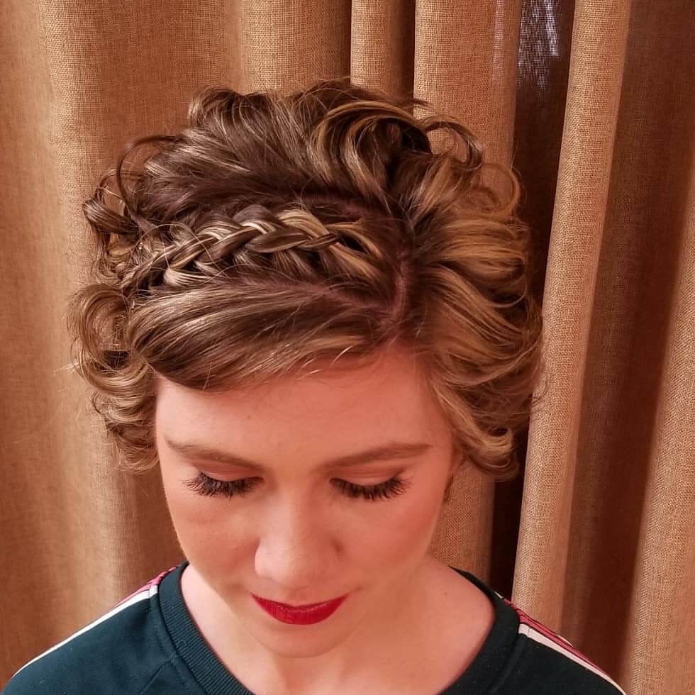 Elegant updo with soft curls and a charming braid