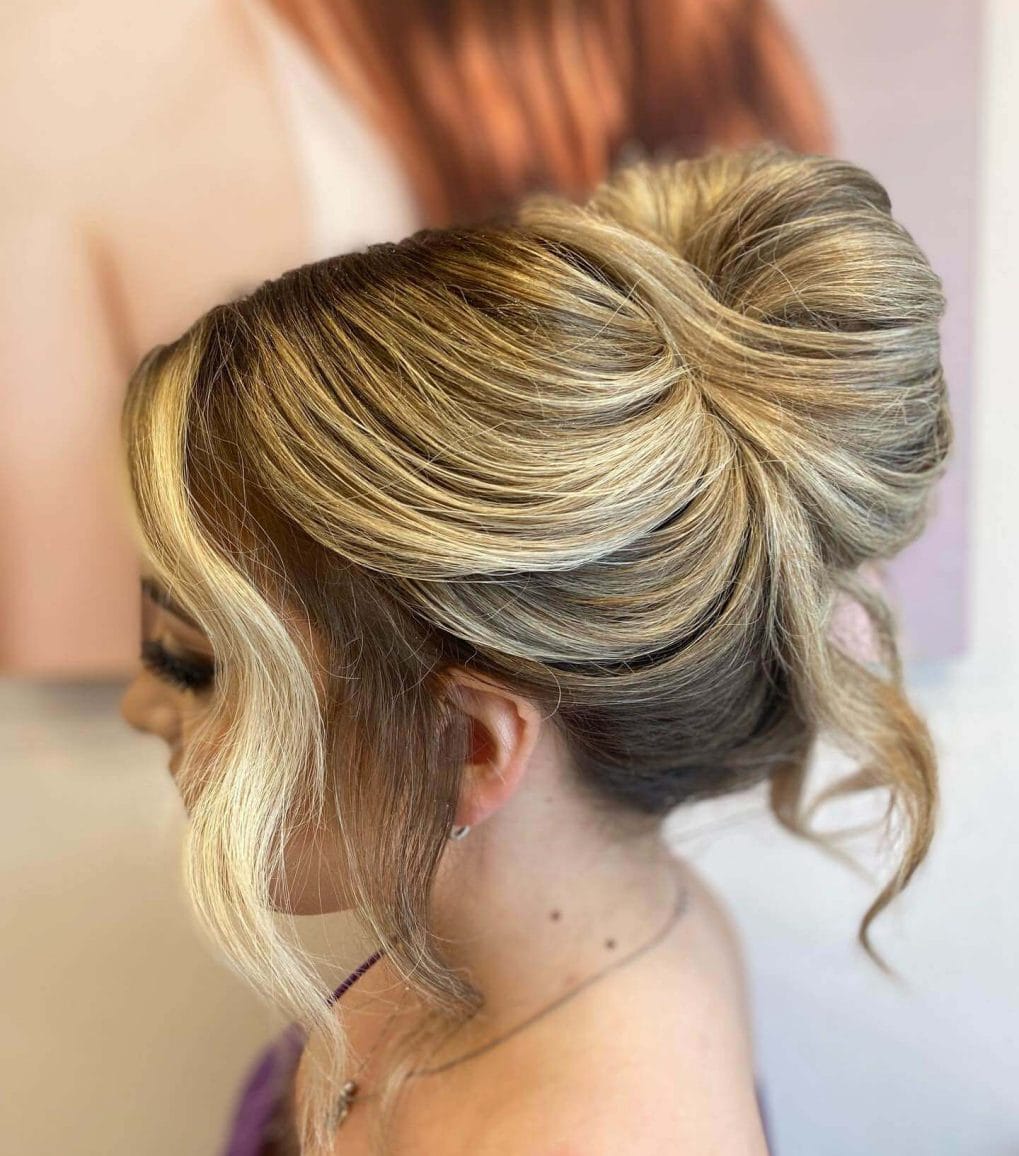 Elegant voluminous updo with soft tendrils framing the face