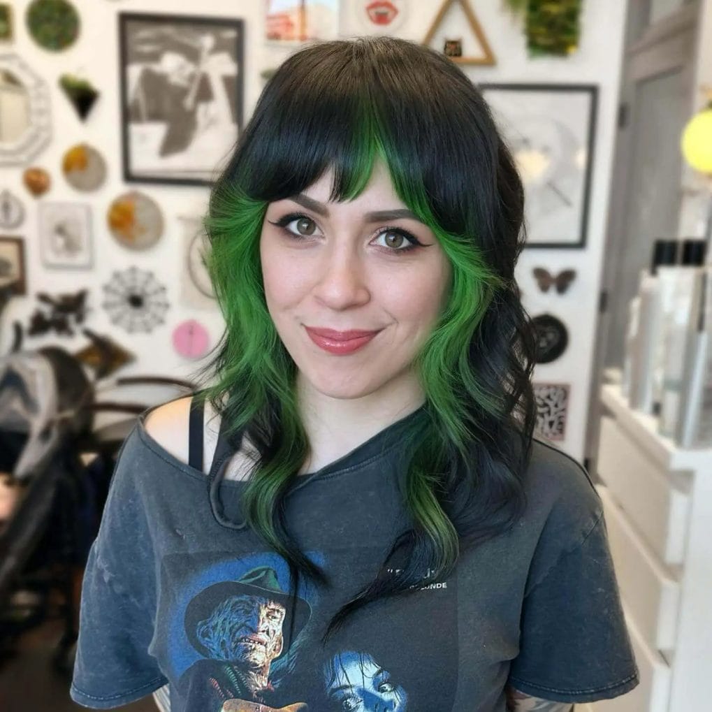 Black waves with bold emerald tips and straight-across bangs