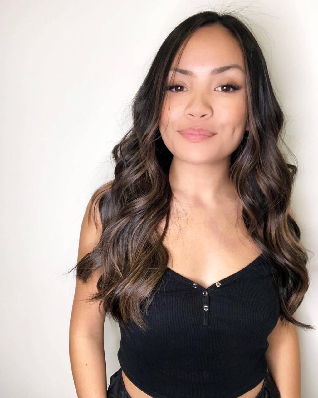 Long layered cut in espresso to warm brunette balayage, reflecting winter's natural hues.