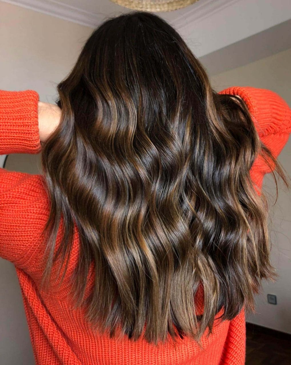 Cascading waves in espresso to hazelnut balayage, embodying the contrast of a winter evening.
