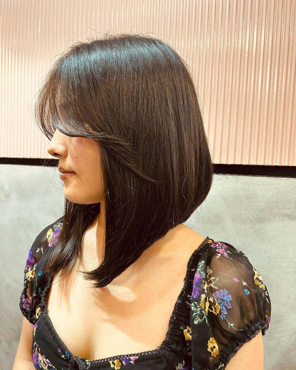 Deep espresso straight bob with full, subtly layered curtain bangs.