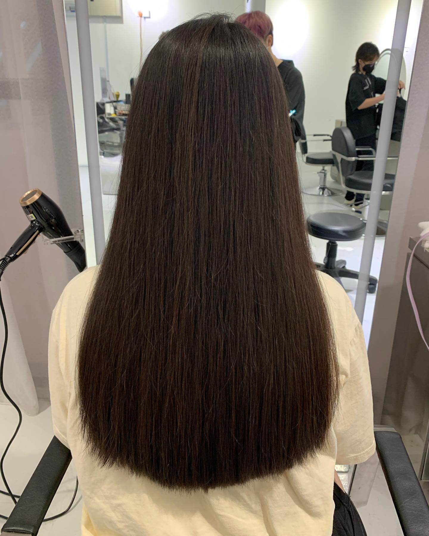 Luxurious espresso U-shaped haircut cascading evenly with a soft curve.