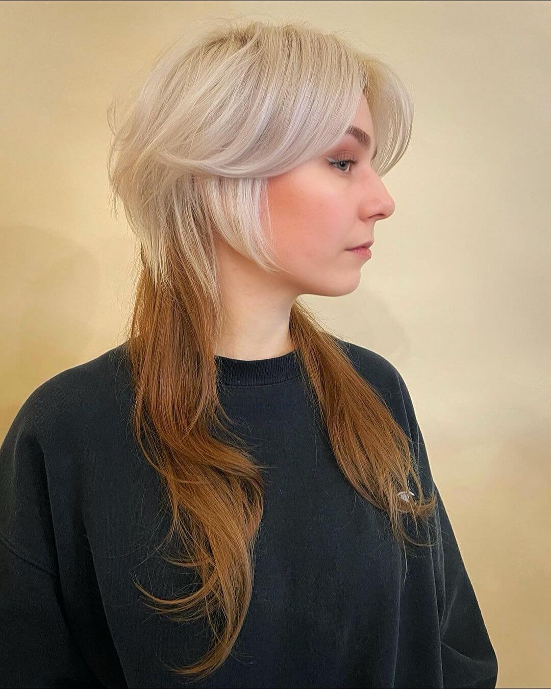 Ethereal jellyfish haircut with face-framing platinum blonde cascades and chestnut undertones.