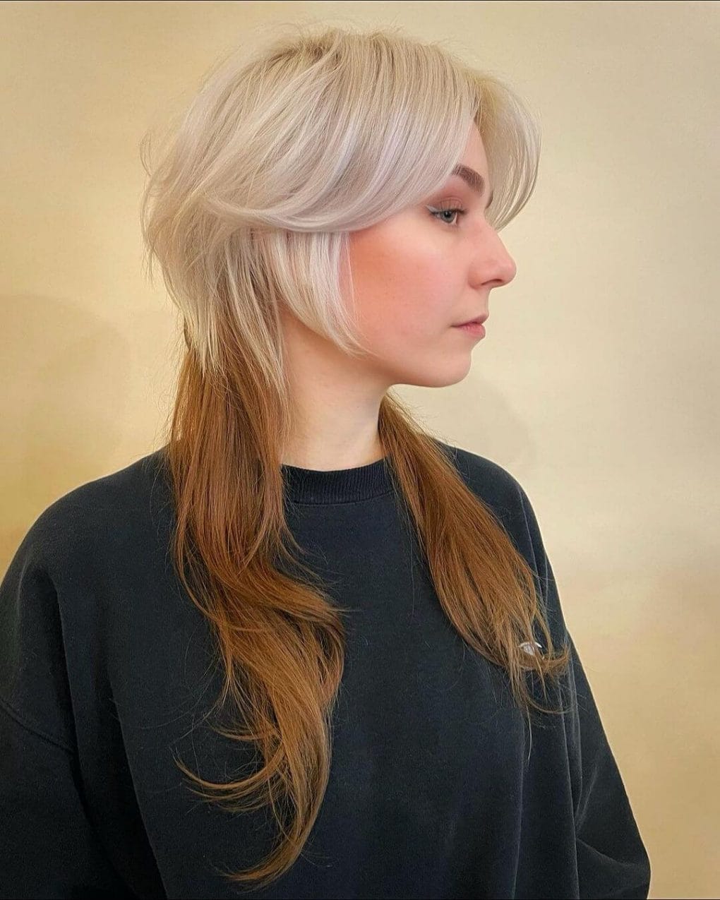 Ethereal jellyfish haircut with face-framing platinum blonde cascades and chestnut undertones.