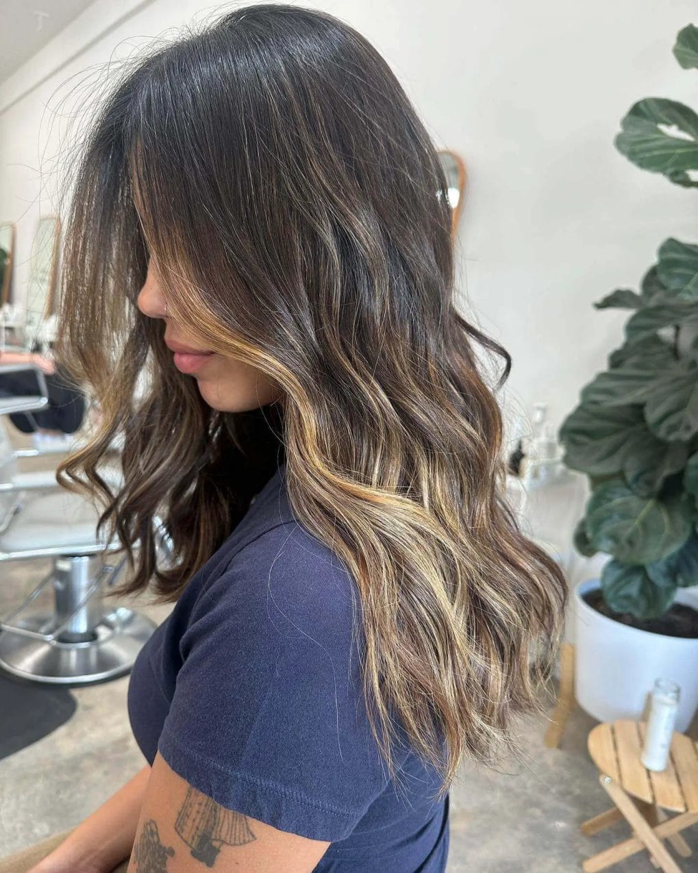 Face-framing layers with seamless balayage on brunette hair.