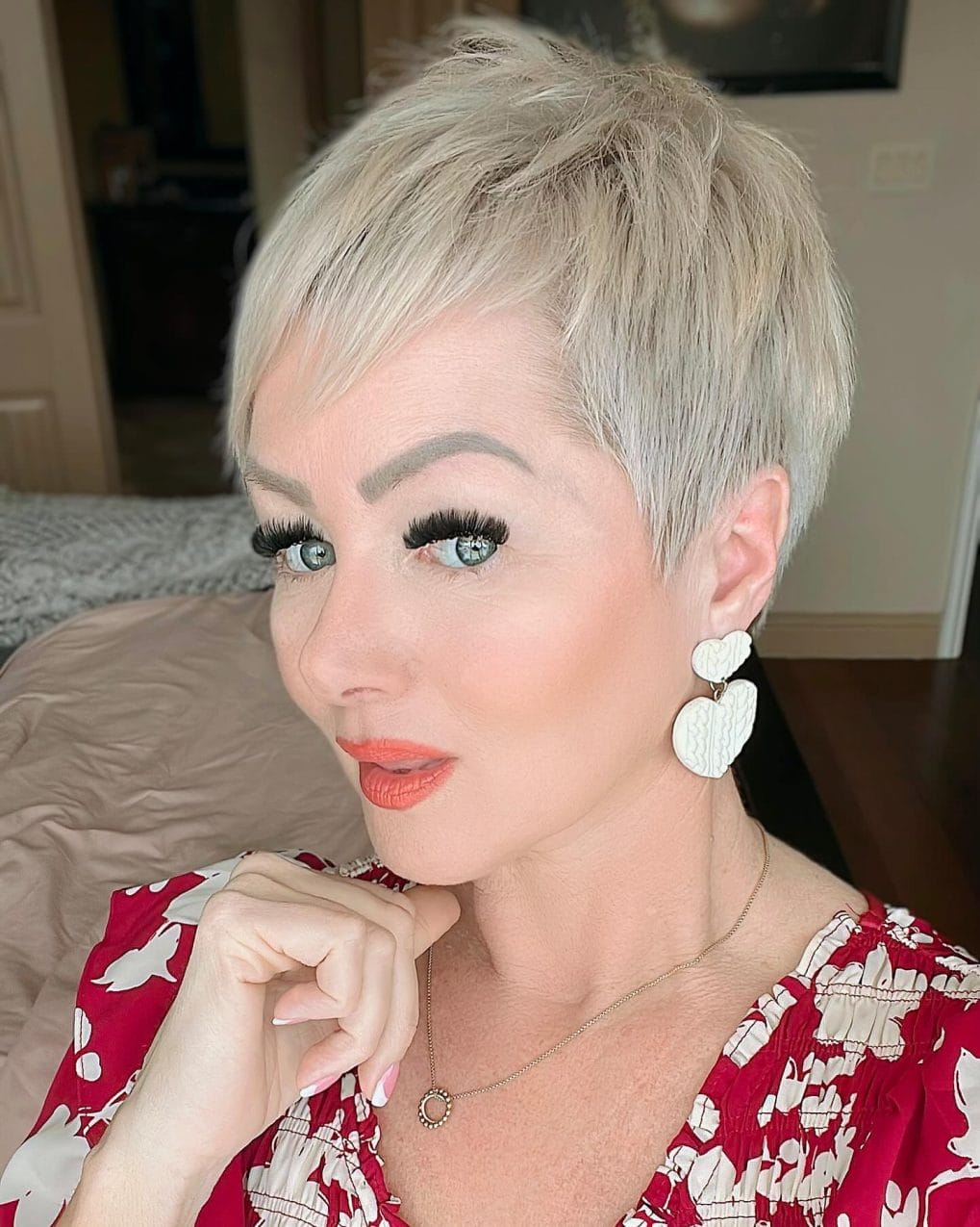 Soft, feminine platinum pixie with side-swept bangs for a versatile look