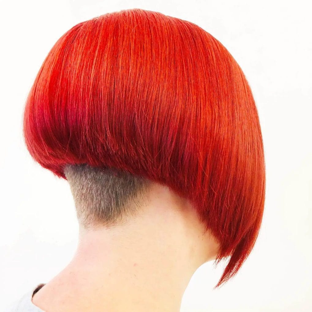 Bold fiery red bowl cut with a sleek, rounded undercut, displaying vivid and uniform color.
