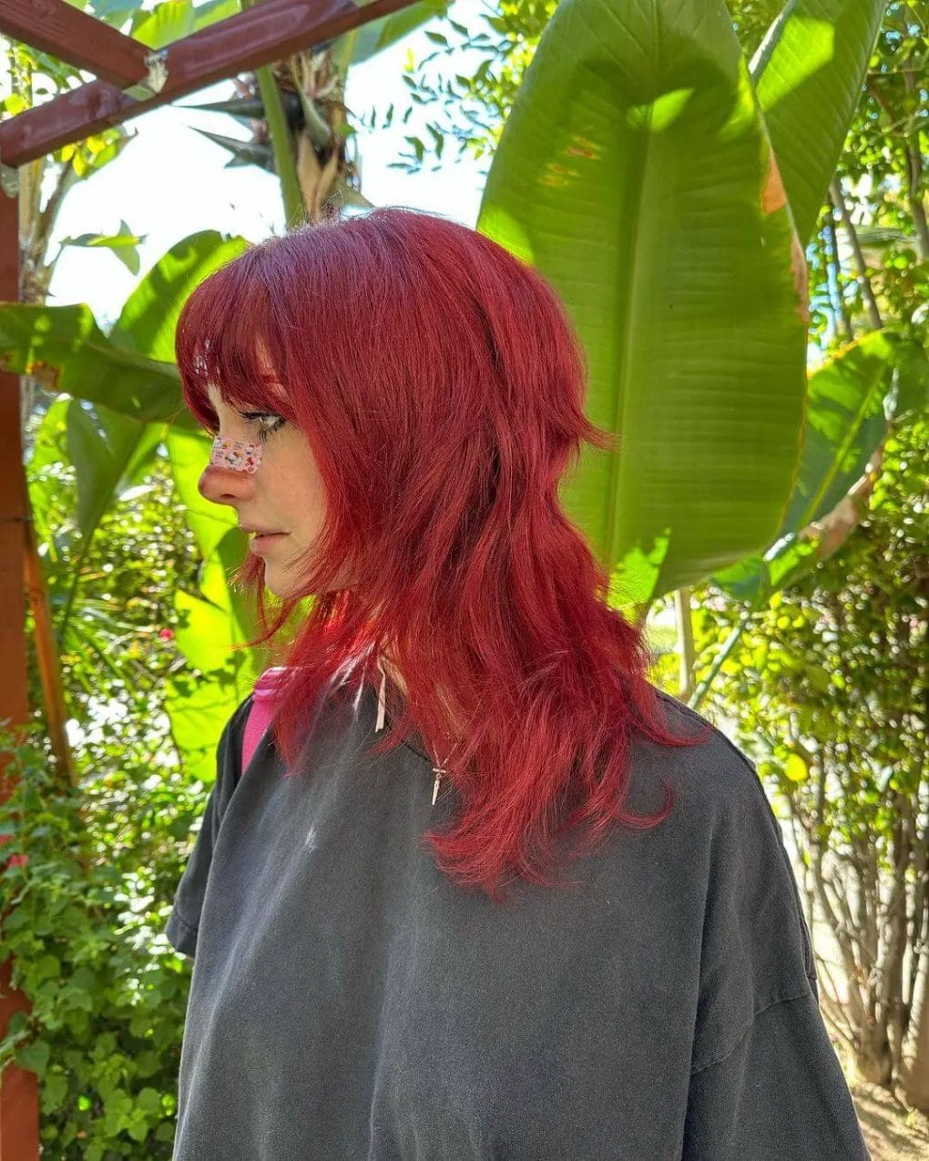 Fiery red layered jellyfish haircut with intense tones and a soft fringe.