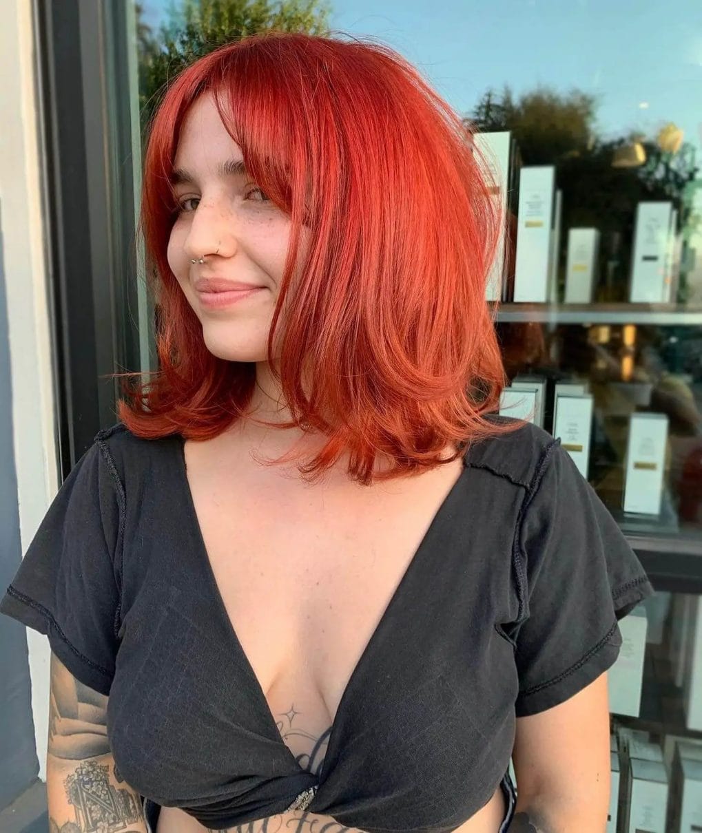Vibrant red wavy shoulder-length hair with fiery undertones.