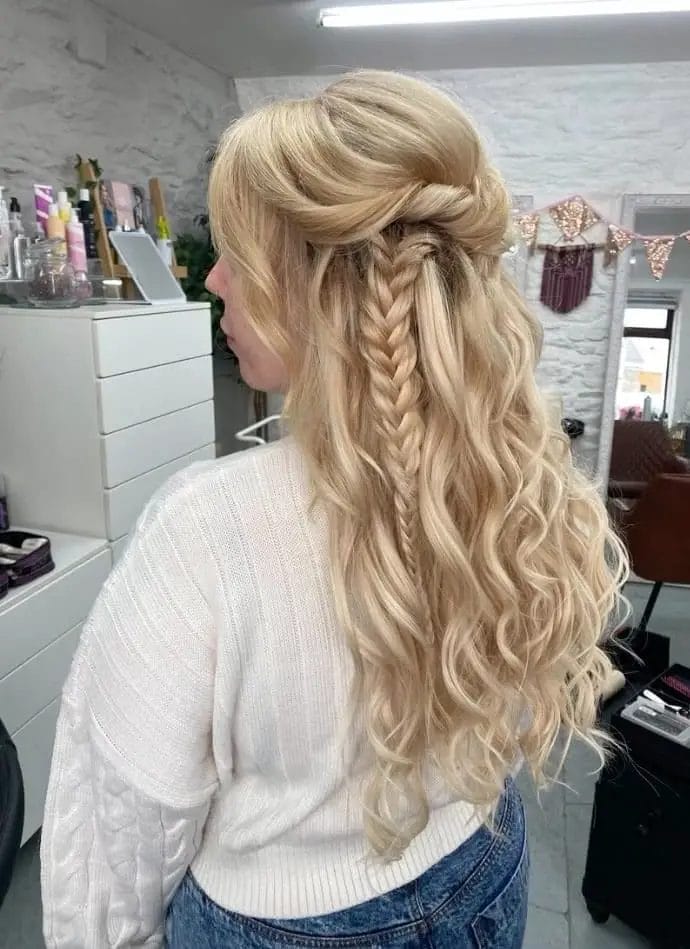 Blonde hair braided half-up leading to a fishtail among waves