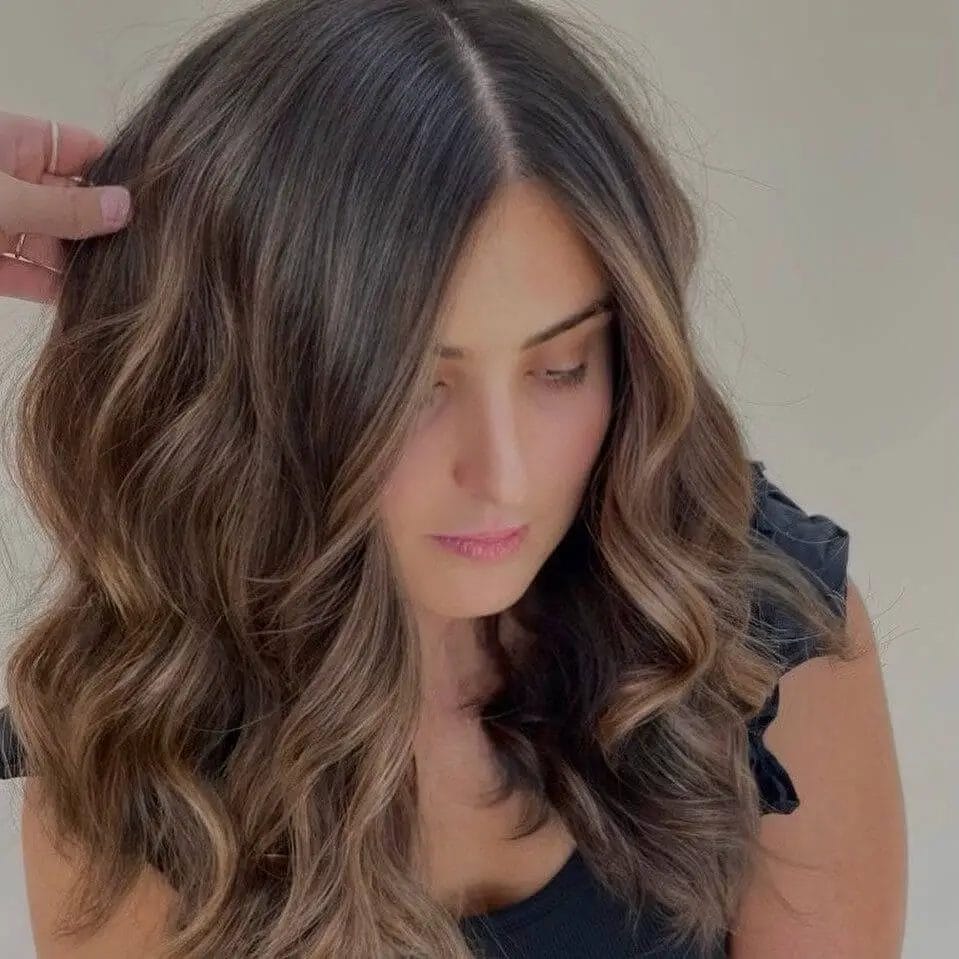 Flowing layers with ash blonde highlights on hair.