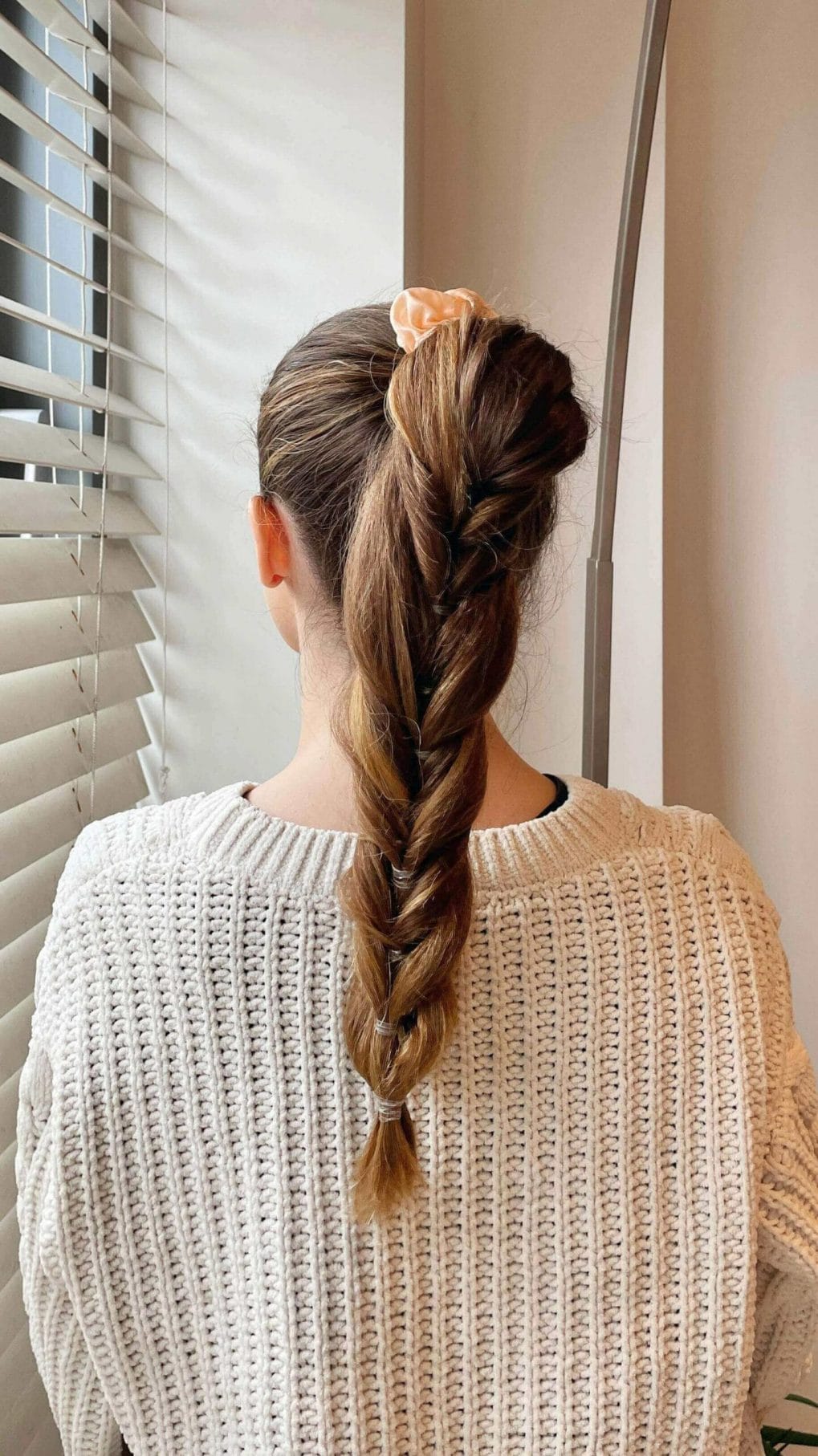 French braid with loose twist and satin bow for a charming athletic hairstyle
