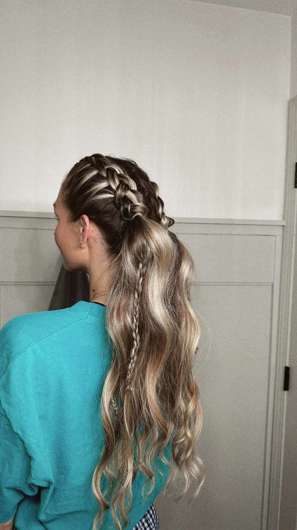 Blonde hair with braid starting from the front into relaxed waves for volleyball ease