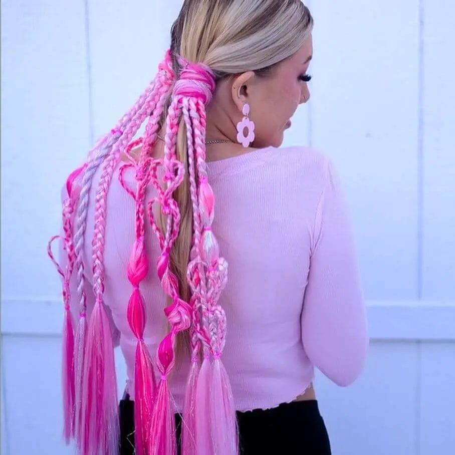Intricate braids in shades of fuchsia and pink with hair rings