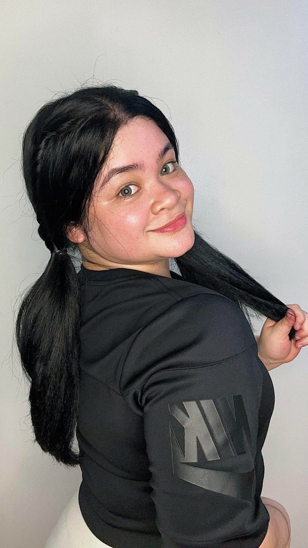Fun pigtails jet-black hairstyle for straightforward softball styling