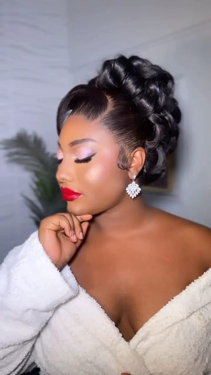 High glossy curls in an elegant updo with styled front