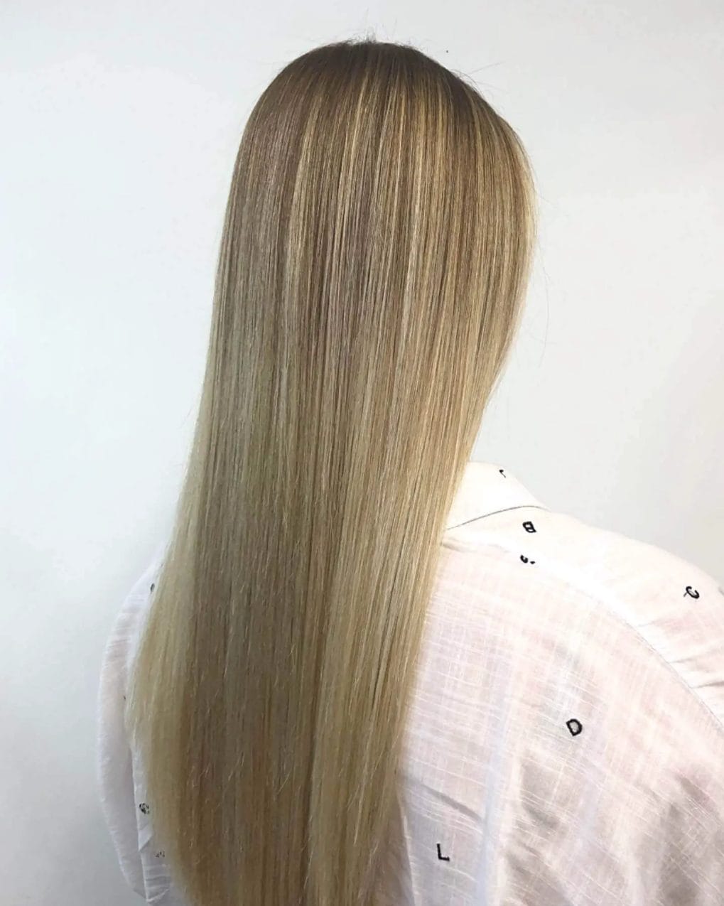 Golden blonde balayage on classic long straight hair.