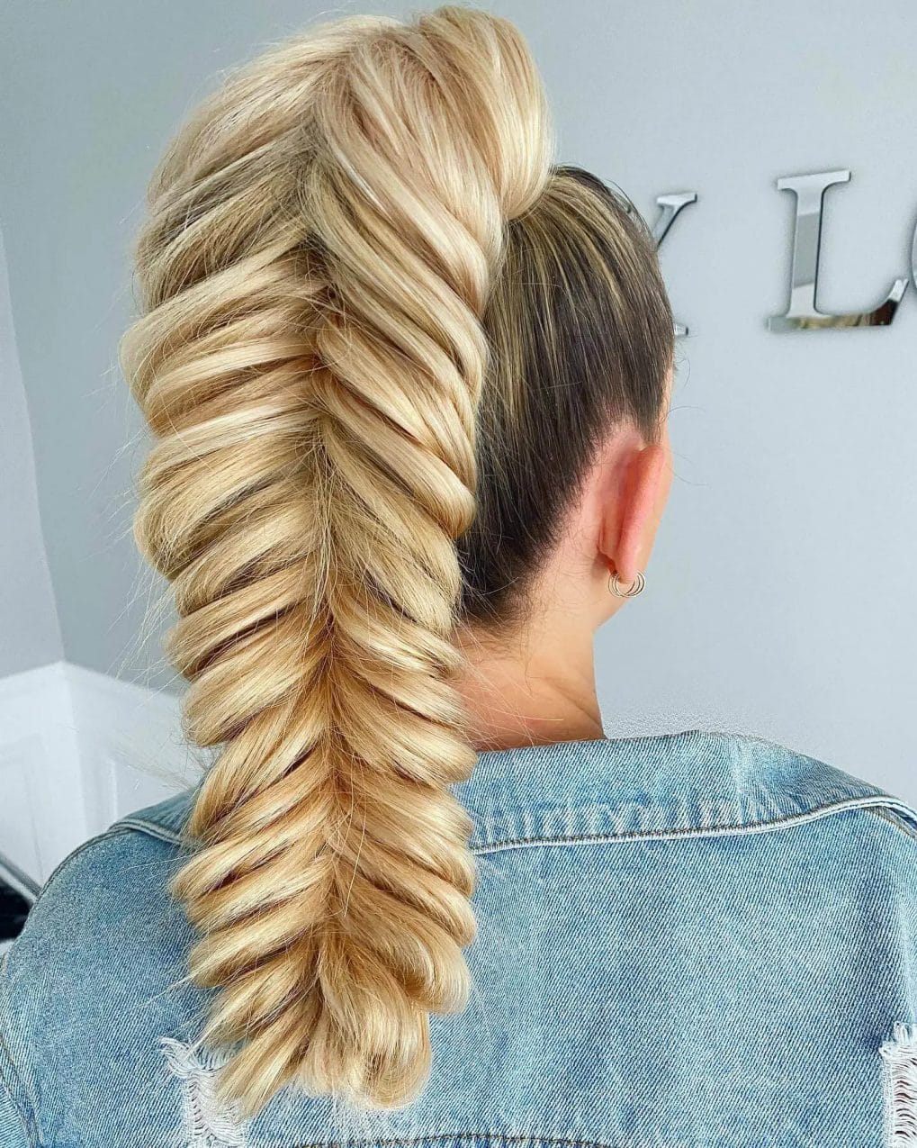 Luxurious golden blonde French braid cascading into a thick ponytail.