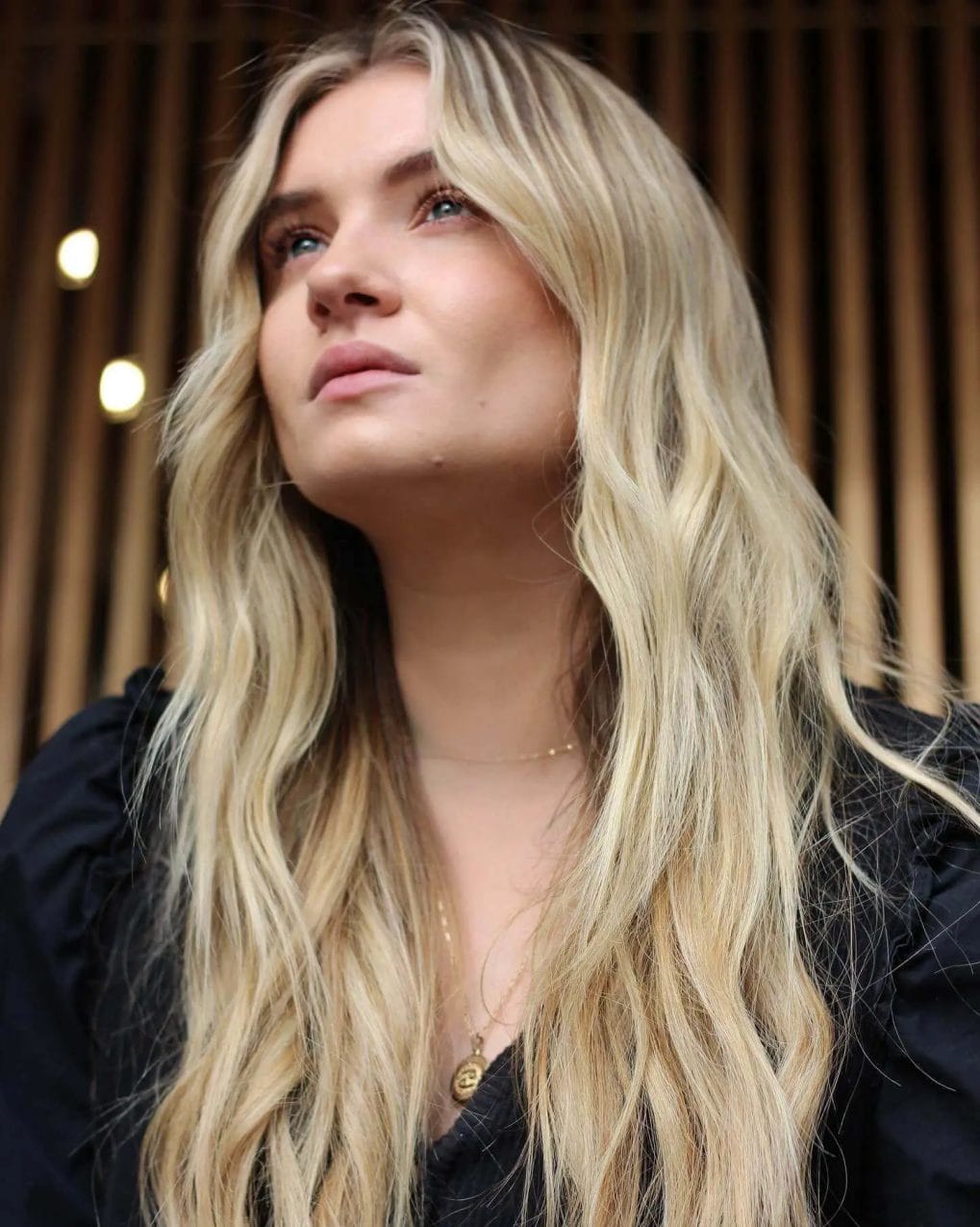 Sunlit golden ombre waves with middle-parted curtain bangs