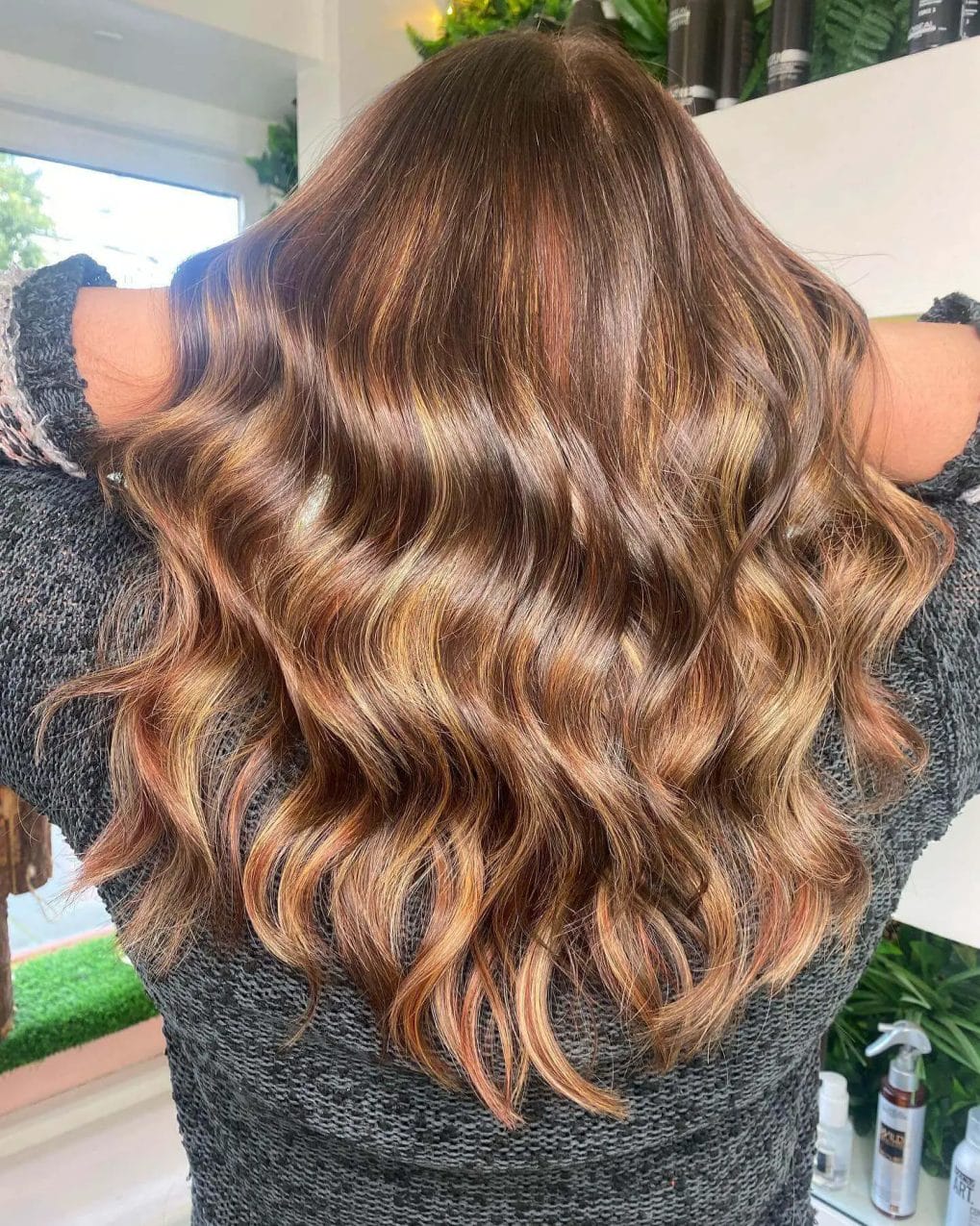 Golden and caramel balayage in rich brunette, reminiscent of winter sunlight.