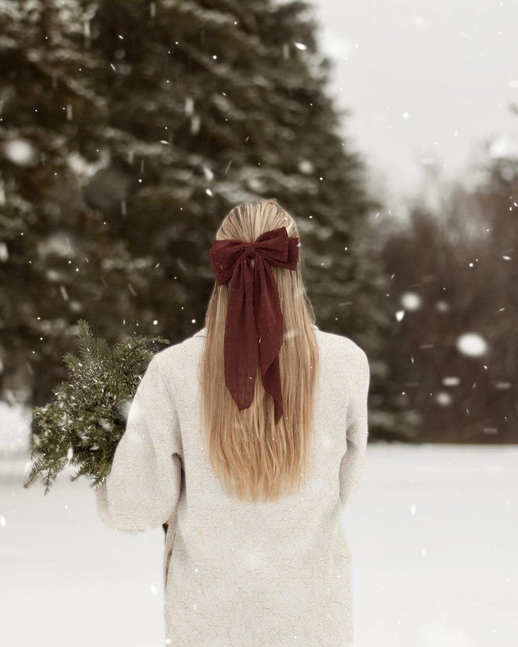 Long, straight golden blonde hair with a velvet ribbon bow