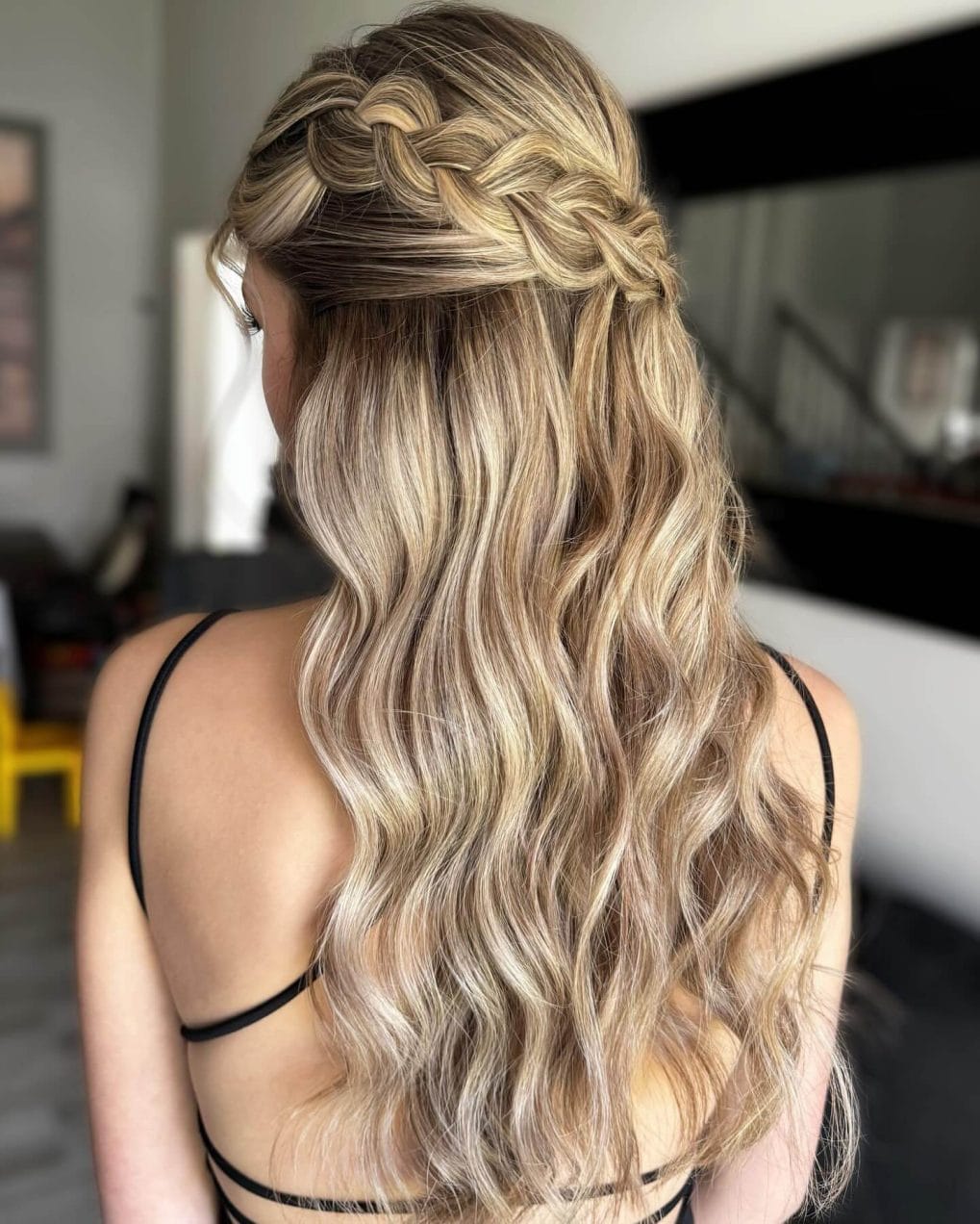 Blonde hair in a half-up style with soft flowing waves