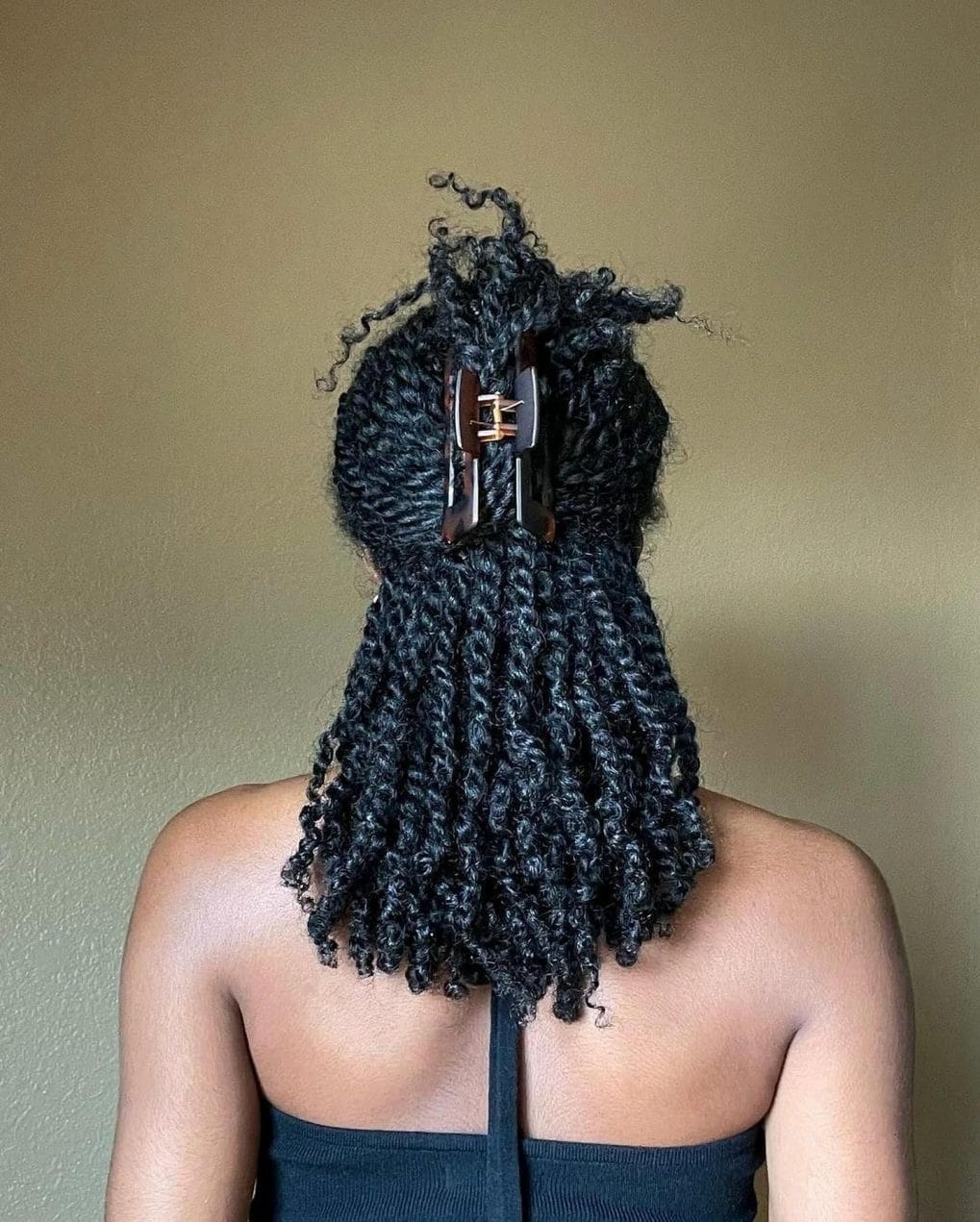 Long kinky twists in a half-up style with playful face-framing curls