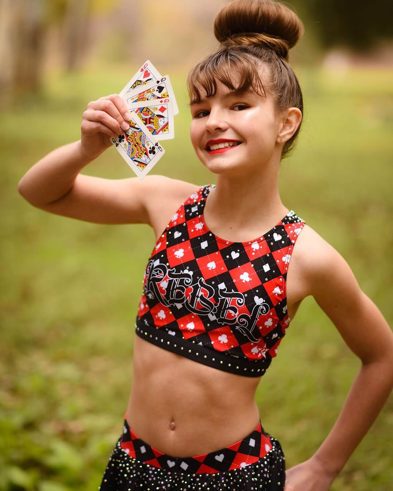 Cheerleader with sleek high bun showcasing joyful expression