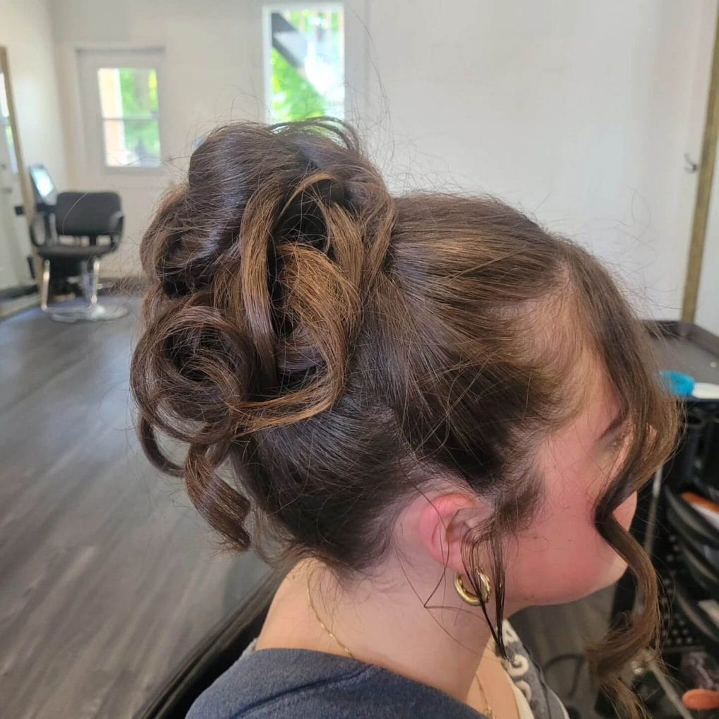 High voluminous bun with artfully arranged loose curls