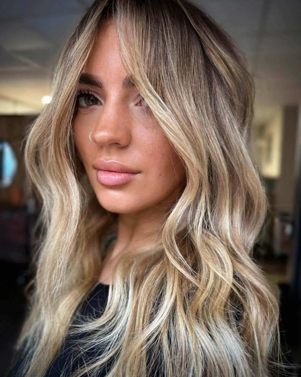 Honey blonde balayage with soft, face-framing layers